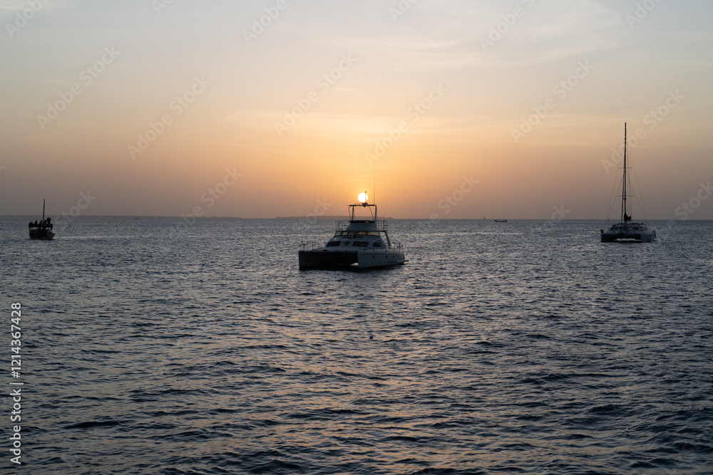 Boats and Sun Dipping Below the Horizon in Zanzibar Boats and Sun Dipping Below the Horizon in Zanzibar
