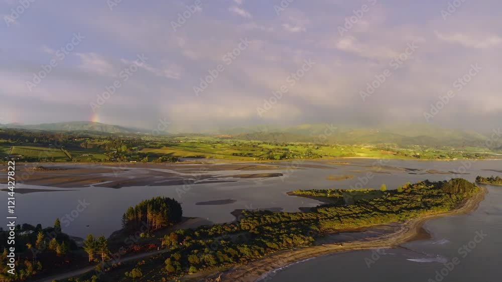 Aerial drone shot of the Tasman coastline and rain clouds over the mountains near Nelson, New Zealand Aerial drone shot of the Tasman coastline and rain clouds over the mountains near Nelson, New Zealand