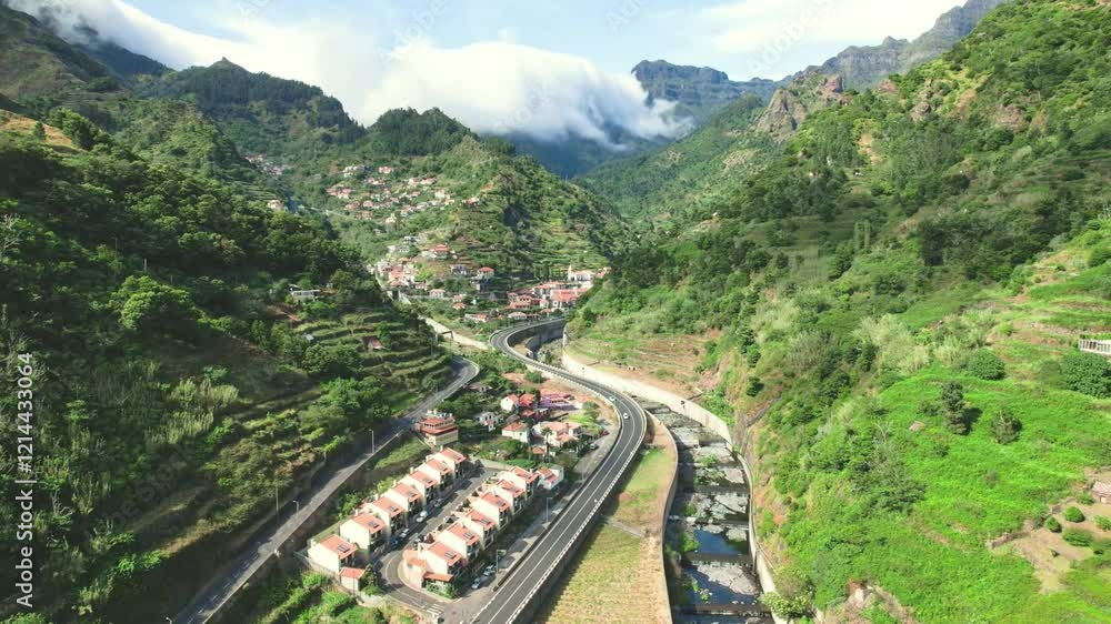 Timelapse of Clouds pouring into charming and nestled village nestled in valley of rolling hills in of Lombo do Moleiro in Ribeira Bravo region of Madeira. Orographic lift by aerial 4k drone. Timelapse of Clouds pouring into charming and nestled village nestled in valley of rolling hills in of Lombo do Moleiro in Ribeira Bravo region of Madeira. Orographic lift by aerial 4k drone.