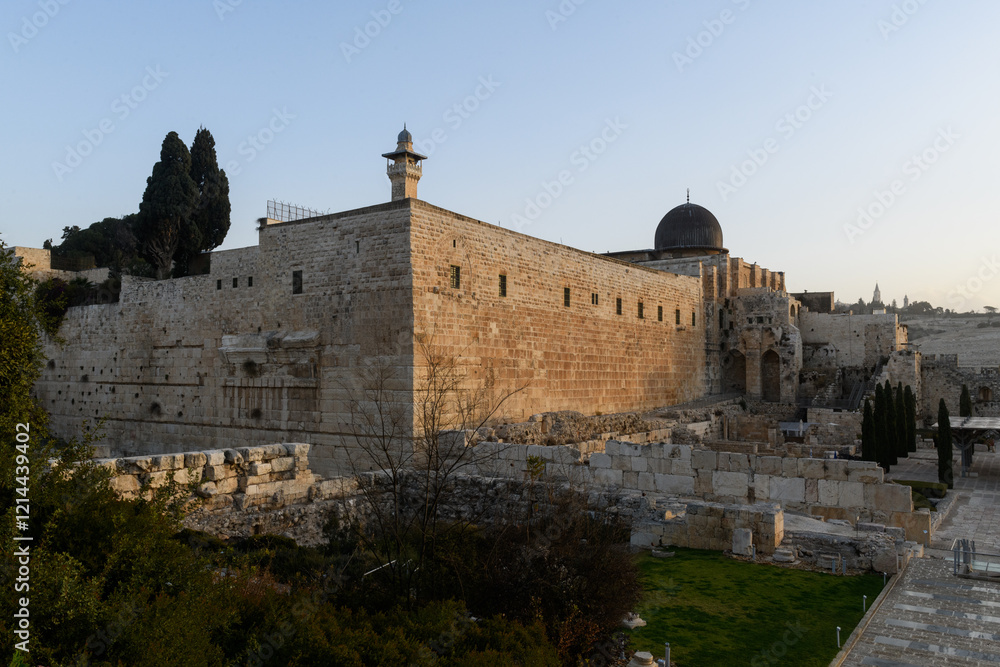 Daylight view of the western and southern walls of the Temple Mount in Jerusalem with a view of the black-domed Al Aqsa mosque and minaret. Daylight view of the western and southern walls of the Temple Mount in Jerusalem with a view of the black-domed Al Aqsa mosque and minaret.