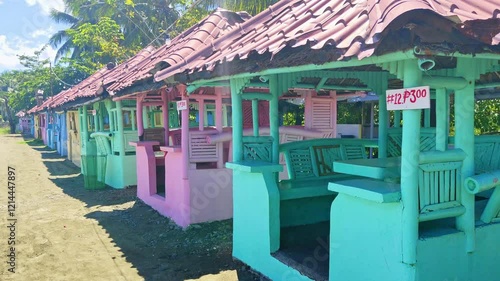 Golden sandy beaches and charming beach huts nestled among lush tropical palm trees in Bacuag, Surigao Del Norte. Perfect for summer vacations, weekend getaways, and tropical adventures under clear bl