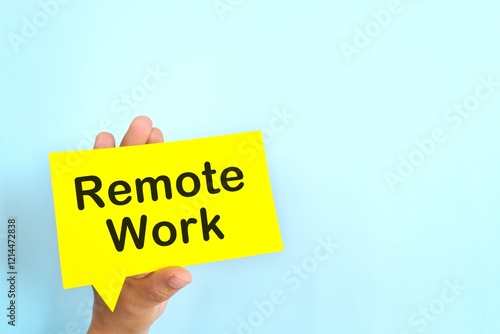 Obraz na płótnie Human hand holding yellow speech bubble with written phrase Remote Work. Hiring for remote work setup. w salonie