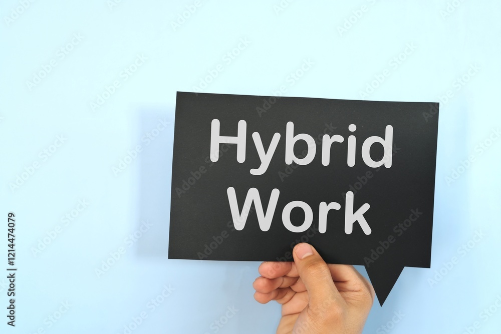 Human hand holding black speech bubble with written phrase Hybrid Work. Hiring for hybrid work setup. Human hand holding black speech bubble with written phrase Hybrid Work. Hiring for hybrid work setup.