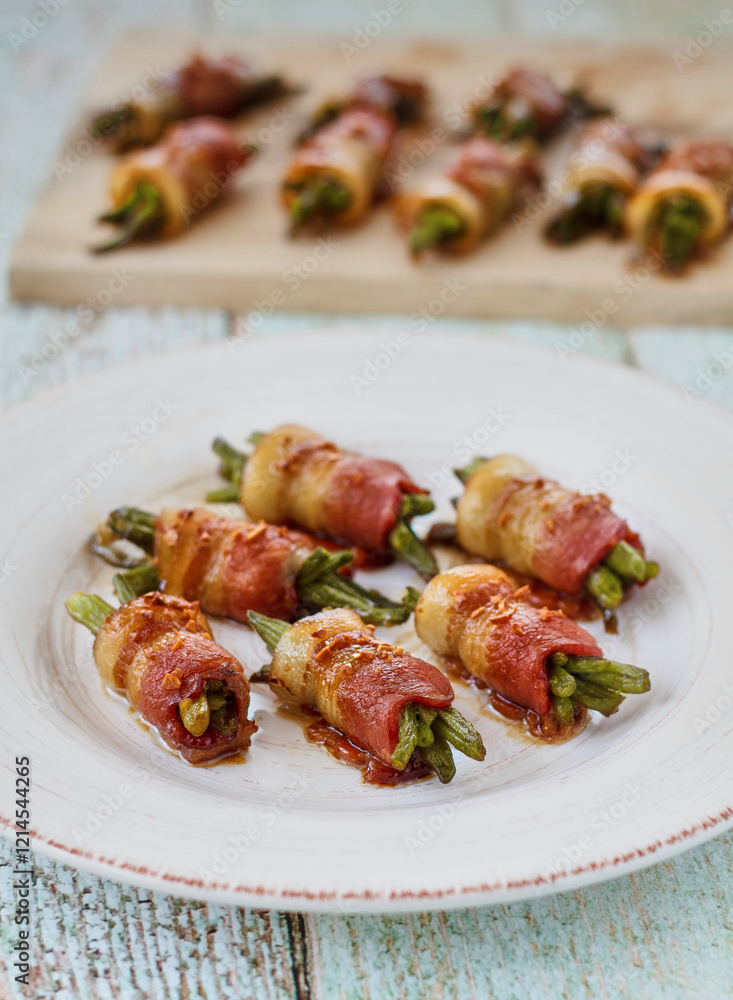 bacon wrapped green beans served on a plate and a cutting board bacon wrapped green beans served on a plate and a cutting board