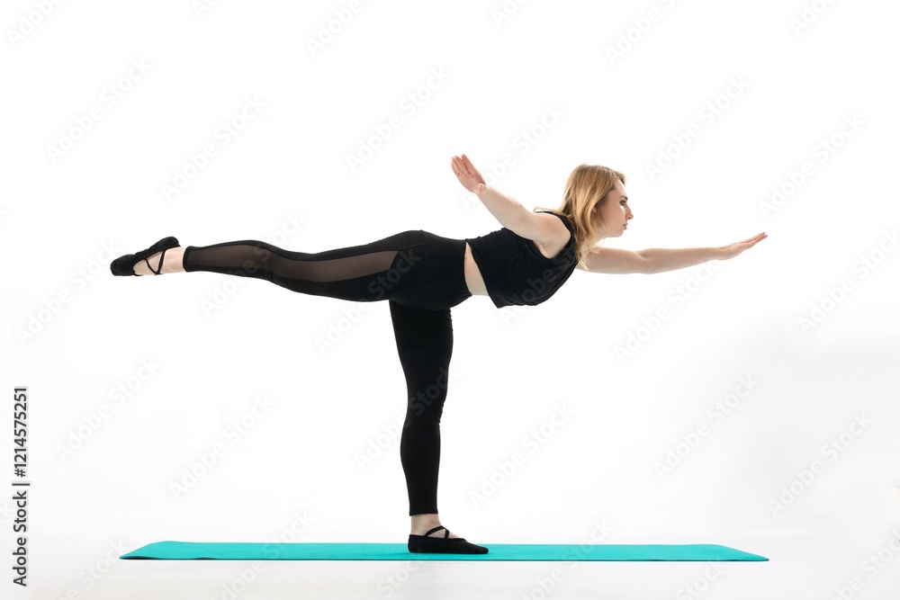Naklejka premium Practicing balance and strength in yoga on a mat during a bright studio session