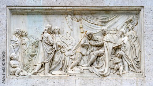 Ancient stone bas relief sculpture part of the Monument to Felipe IV in the Plaza del Palacio Real, Madrid, Spain photo