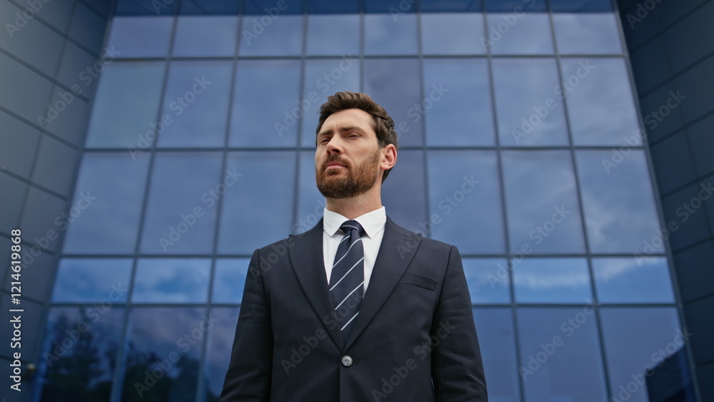 Confident leader looking camera with thoughtful demeanor against office closeup Confident leader looking camera with thoughtful demeanor against office closeup