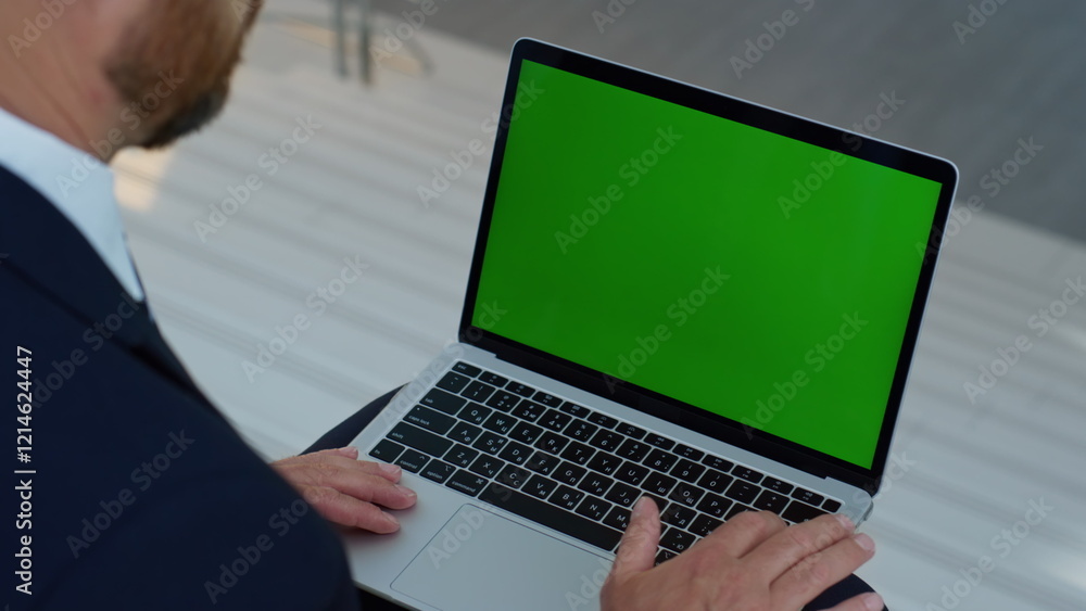 Ceo watching greenscreen laptop on office stairs closeup. Unrecognizable man Ceo watching greenscreen laptop on office stairs closeup. Unrecognizable man
