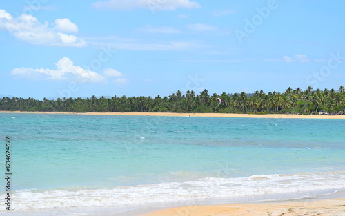 Las Terrenas beach with kite surfer in distance in Dominica Republic.