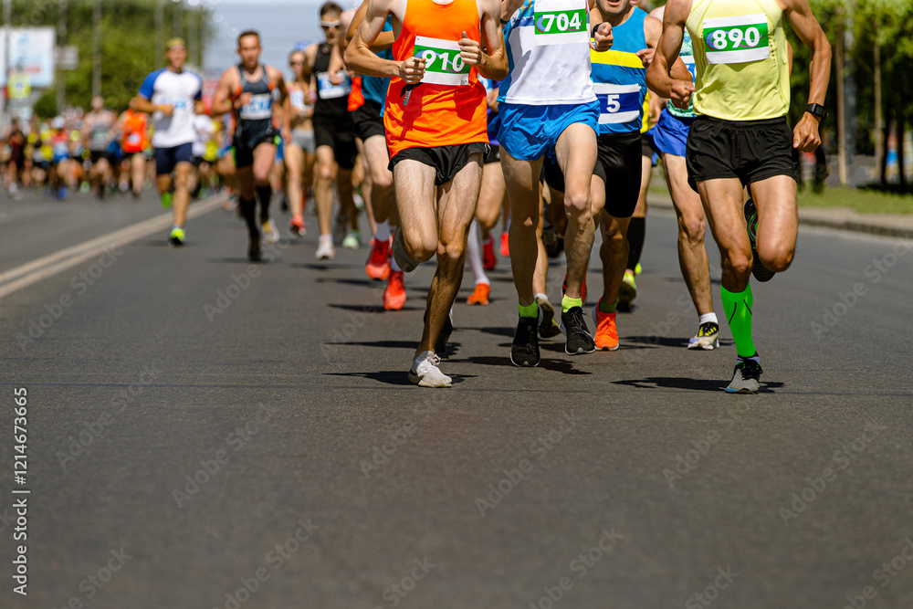 dozens runners sprint down wide city road during competitive race. dozens runners sprint down wide city road during competitive race.
