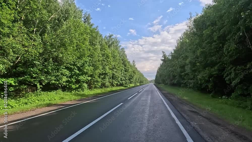 Highways, roadside and road line markings. The car drives along the road on a summer day. Highways, roadside and road line markings. The car drives along the road on a summer day.