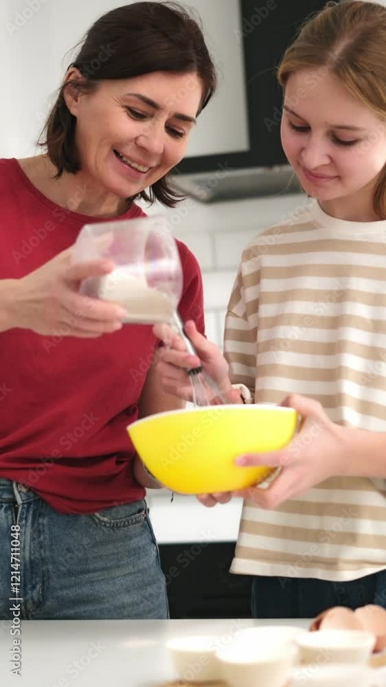 Cute Little Girl And Mother Cooking Sweets In The Kitchen, Making Homemade Muffins, Vertical Video Cute Little Girl And Mother Cooking Sweets In The Kitchen, Making Homemade Muffins, Vertical Video