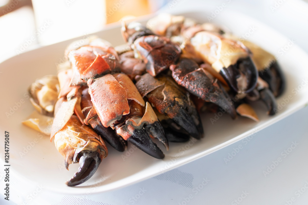 Steamed stone crab claws served with a spicy seafood dipping sauce are popular dishes in local street food in Thailand. Steamed stone crab claws served with a spicy seafood dipping sauce are popular dishes in local street food in Thailand.