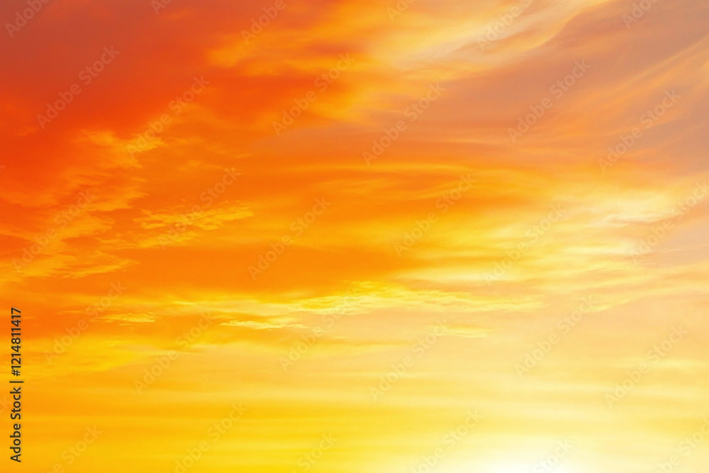Fototapeta premium stunning gradient of fiery orange fading into golden yellow, creating warm and vibrant sky. This beautiful sunset evokes feelings of tranquility and awe