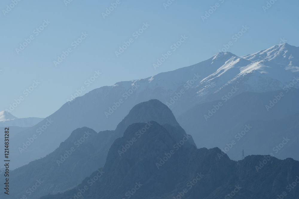 Snowy mountains on a sunny day. Mountain peak against blue sky. Antalya, Türkiye Snowy mountains on a sunny day. Mountain peak against blue sky. Antalya, Türkiye