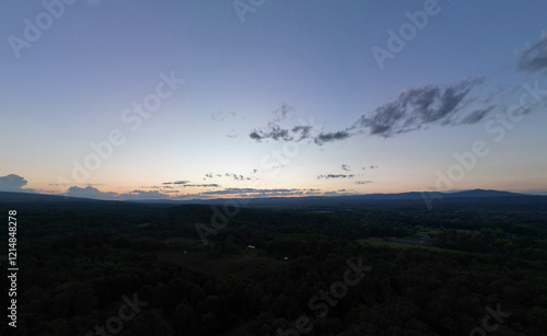 view of catskill mountains at sunset (wide angle aerial mountain vista in catskills hudson valley slide mountain wilderness hiking area) dramatic huge puffy clouds sky cloud formation farm rural area photo