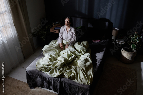 Photos High angle shot of adult woman suffering from sleepwalking sitting in middle of