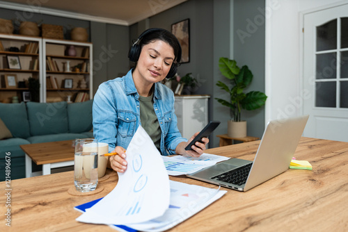 Young introvert freelancer businesswoman with ADHD working remotely from home office on laptop computer. Business person avoiding crowded office and people by working alone at apartment on computer.
