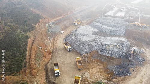 Construction trucks and machinery working on a construction site