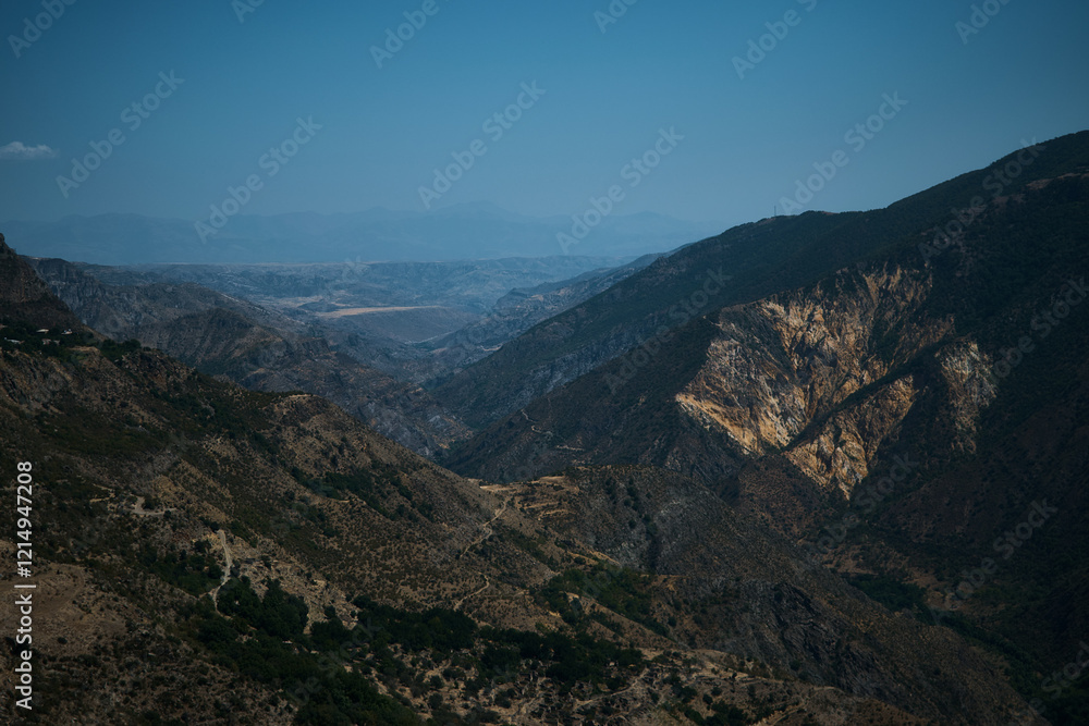 a view of the mountain road, city and mountains from the funicular near Tatev Monastery a view of the mountain road, city and mountains from the funicular near Tatev Monastery