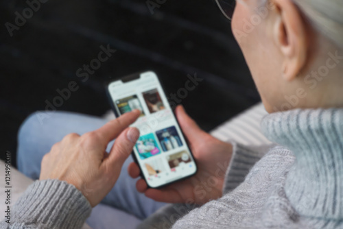 Senior woman scrolling through products on her smartphone