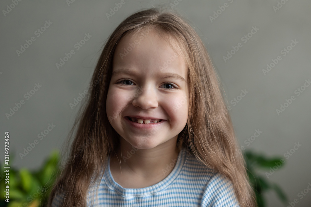 Smiling caucasian female child with long hair in striped shirt Smiling caucasian female child with long hair in striped shirt