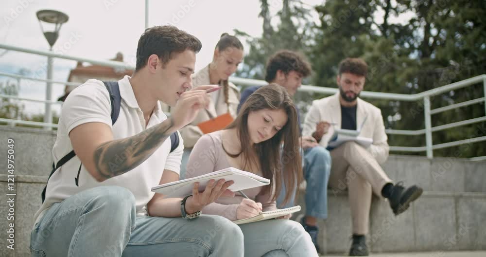 Students attending an outdoor class and interacting with a professor, receiving help with tasks when needed. Students attending an outdoor class and interacting with a professor, receiving help with tasks when needed.