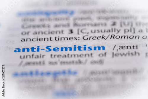 Photos Anti Semitism word in a dictionary. Selective focus, close up.