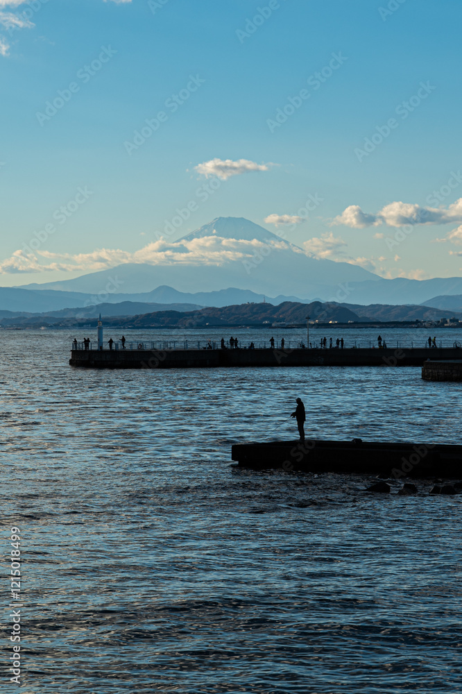 Fishing at sunset by the ocean mount fuji in the background scenic landscape peaceful waters wide angle view Fishing at sunset by the ocean mount fuji in the background scenic landscape peaceful waters wide angle view
