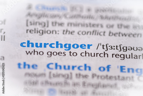 Churchgoer word in a dictionary. Selective focus, close up. photo