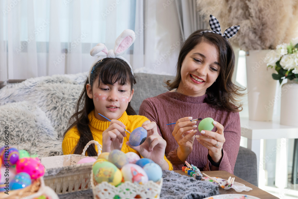 A mother and daughte painting colorful Easter eggs together A mother and daughte painting colorful Easter eggs together