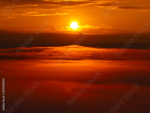 Obraz na płótnie A breathtaking sunrise above a sea of clouds, capturing vibrant orange and yellow hues in the sky. Amazing sunrise photo aerial view between layers of clouds, landscape photo. w salonie