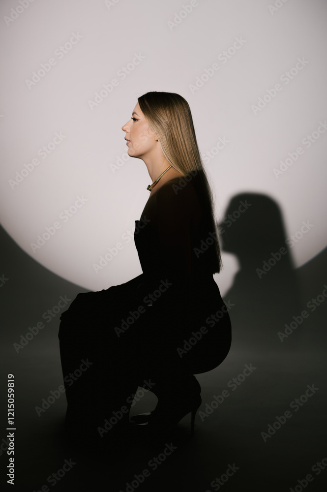 Portrait of a woman in a studio with professional lighting in a smart dress with gloves