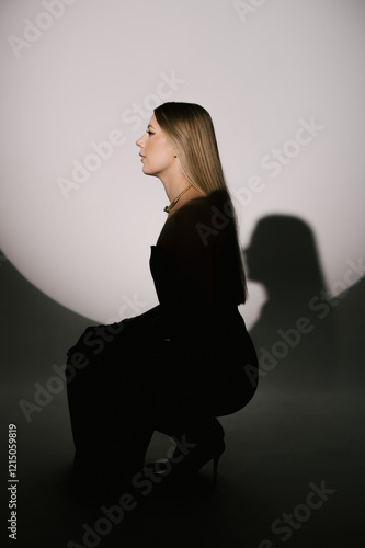 Obraz na płótnie Portrait of a woman in a studio with professional lighting in a smart dress with gloves w salonie