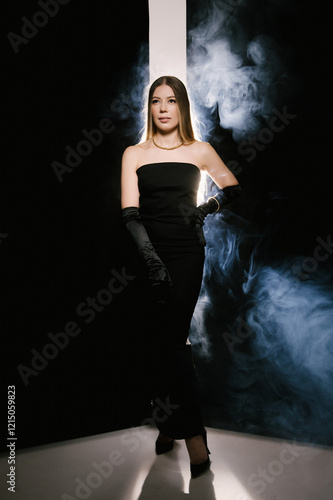Obraz na płótnie Portrait of a woman in a studio with professional light and smoke in a smart dress with gloves w salonie