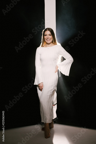 Obraz na płótnie Portrait of a woman in a studio with professional lighting in a white long dress, soft focus w salonie