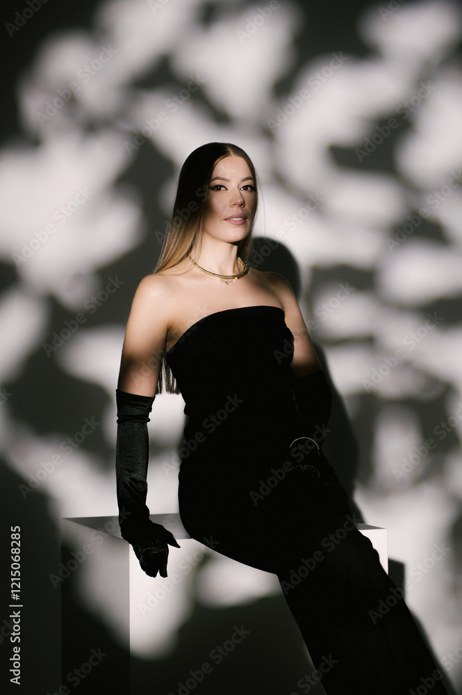 Portrait of a woman in a studio with professional lighting in a smart dress with gloves