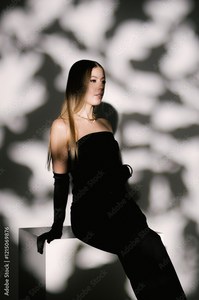 Portrait of a woman in a studio with professional lighting in a smart dress with gloves