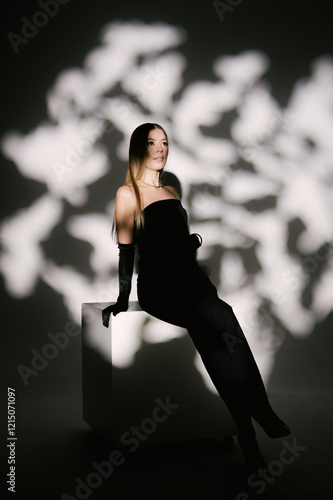 Obraz na płótnie Portrait of a woman in a studio with professional lighting in a smart dress with gloves w salonie