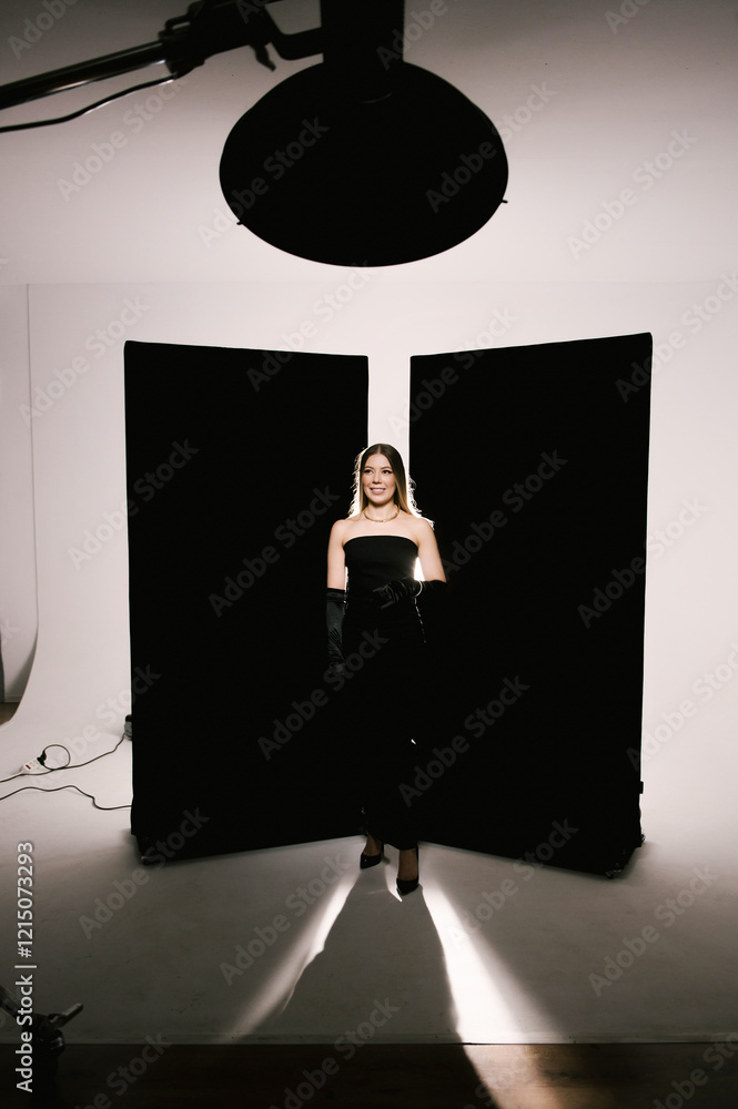 Portrait of a woman in a studio with professional lighting in a smart dress with gloves