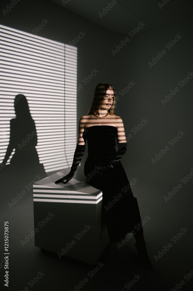 Portrait of a woman in a studio with professional lighting in a smart dress with gloves