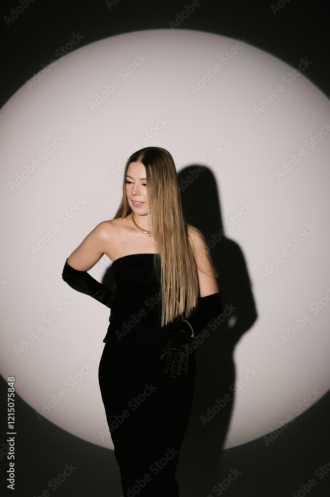Portrait of a woman in a studio with professional lighting in a smart dress with gloves