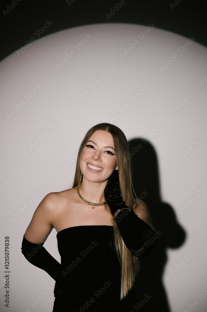 Portrait of a woman in a studio with professional lighting in a smart dress with gloves