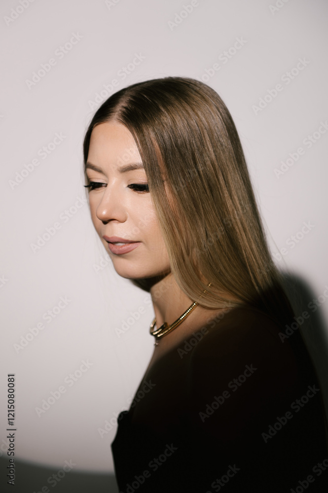 Portrait of a woman in a studio with professional lighting in a smart dress with gloves
