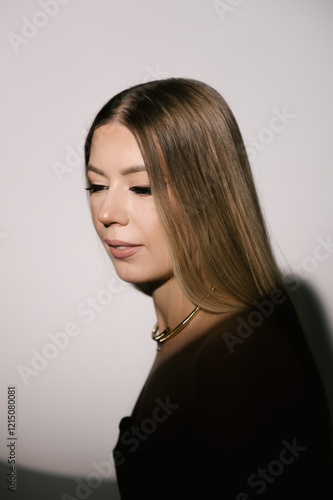 Obraz na płótnie Portrait of a woman in a studio with professional lighting in a smart dress with gloves w salonie