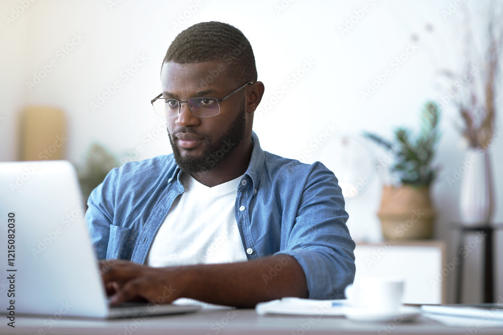 Remote Work. Handsome african Freelancer Guy Working On Laptop At Home Office, Sitting At Desk With Computer, Smiling African American Man Looking At Device Screen, Enjoying Freelance Job, Copy Space Remote Work. Handsome african Freelancer Guy Working On Laptop At Home Office, Sitting At Desk With Computer, Smiling African American Man Looking At Device Screen, Enjoying Freelance Job, Copy Space