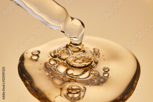 A pipette with a beautiful drop of gel-textured facial serum.