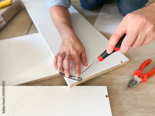Wallpaper Mural Man assembling new furniture at home do-it-yourself concept Torontodigital.ca
