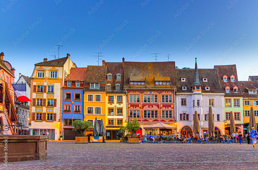 Fototapeta premium Mulhouse cityscape, typical houses colorful buildings and street restaurant outdoor café on Place de la Reunion square in old town Mulhouse city historic centre, Alsace Grand Est region, France