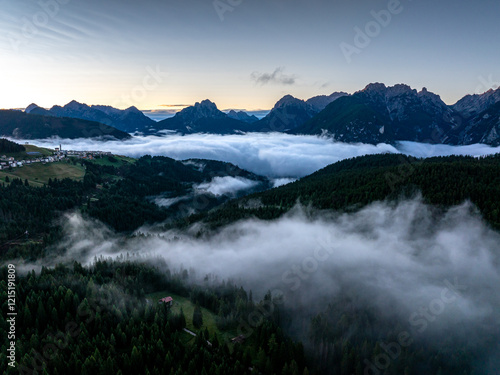Obraz na płótnie Scenic aerial morning view of misty valleys and forested landscapes in the Dolomites, with Antelao and Cridola peaks in the background. Captured near Danta village, Italy. Hiking in Dolomites. w salonie